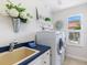 Laundry room featuring modern appliances, a sink, and natural light from the window at 33724 Americana Ave, Dade City, FL 33525