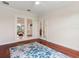 Living room with hardwood floors and view through French doors into another living space at 33724 Americana Ave, Dade City, FL 33525