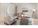 Bright living room featuring neutral tones, stylish furnishings, and tiled flooring, creating an inviting atmosphere at 33724 Americana Ave, Dade City, FL 33525
