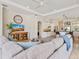 Open-concept living room boasting tray ceilings, tile floors, and view into kitchen at 33724 Americana Ave, Dade City, FL 33525