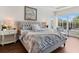 Serene main bedroom featuring a plush bed, hardwood floors, and an abundance of natural light at 33724 Americana Ave, Dade City, FL 33525