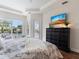 Comfortable main bedroom with backyard views through a sliding glass door and windows at 33724 Americana Ave, Dade City, FL 33525