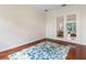 Bright office space featuring a blue patterned rug and glass doors that offer a view of the house at 33724 Americana Ave, Dade City, FL 33525