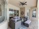 Covered outdoor patio with comfortable seating, stylish decor, and a ceiling fan at 33724 Americana Ave, Dade City, FL 33525
