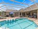 Spacious screened-in pool area with sun loungers and an outdoor dining area at 33724 Americana Ave, Dade City, FL 33525