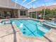 Sparkling pool and spa area surrounded by a screened enclosure, perfect for outdoor relaxation and entertainment at 33724 Americana Ave, Dade City, FL 33525