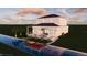 Contemporary two-story home with covered lanai and an expansive waterfront pool and dock at 5243 Wishing Arch Dr, Apollo Beach, FL 33572