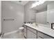 Bright bathroom features a vanity with white countertop and gray cabinetry, plus a toilet and shower with curtain at 5243 Wishing Arch Dr, Apollo Beach, FL 33572