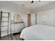 Bright bedroom with hardwood floors features a dresser with modern decor and closet space at 5243 Wishing Arch Dr, Apollo Beach, FL 33572