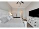 Bright bedroom boasts a ceiling fan, modern floors, and stylish white furnishings at 5243 Wishing Arch Dr, Apollo Beach, FL 33572