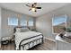 Comfortable bedroom boasts three bright windows, modern ceiling fan, and hardwood floors at 5243 Wishing Arch Dr, Apollo Beach, FL 33572
