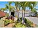 Inviting two-story home with lush landscaping, a paver driveway, and a two-car garage at 5243 Wishing Arch Dr, Apollo Beach, FL 33572