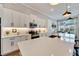 Bright kitchen featuring white cabinets, quartz countertops, subway tile backsplash, and modern lighting at 5243 Wishing Arch Dr, Apollo Beach, FL 33572