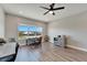 Home office featuring modern floors, a ceiling fan, and views of the yard at 5243 Wishing Arch Dr, Apollo Beach, FL 33572