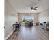Spacious home office features modern floors, a ceiling fan, and views of the yard at 5243 Wishing Arch Dr, Apollo Beach, FL 33572