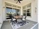Covered patio with black and white rug, round wooden table, and stylish chairs with views of the outdoors at 5243 Wishing Arch Dr, Apollo Beach, FL 33572