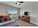 Spacious bedroom with a bed, dresser, and window with backyard view at 5243 Wishing Arch Dr, Apollo Beach, FL 33572