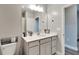 Modern bathroom boasts a vanity with white countertop and gray cabinets at 5243 Wishing Arch Dr, Apollo Beach, FL 33572