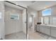 Spa-like bathroom with a large walk-in shower and gray vanity at 5243 Wishing Arch Dr, Apollo Beach, FL 33572