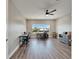 Home office with a large window, hardwood flooring and two desks at 5243 Wishing Arch Dr, Apollo Beach, FL 33572