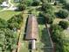 Overhead shot of home with fenced yard, trees, and adjacent pond at 12922 672 Hwy, Riverview, FL 33579