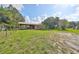 Exterior shot of a building with a metal roof and green grass in a fenced area at 12922 672 Hwy, Riverview, FL 33579