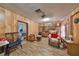 An ample living room with wood paneling, ceiling fan, and laminate flooring at 12922 672 Hwy, Riverview, FL 33579