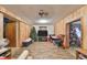 An ample living room with wood paneling, ceiling fan, and laminate flooring at 12922 672 Hwy, Riverview, FL 33579