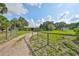 Fenced property with a long driveway, an open garage, and several outbuildings at 12922 672 Hwy, Riverview, FL 33579