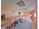 An empty pink room featuring tiled floors, a ceiling fan, and a window AC unit at 12922 672 Hwy, Riverview, FL 33579