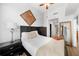 Bright bedroom features a ceiling fan, a decorative mirror, and a closet with ample storage at 1120 E Kennedy Blvd # 827, Tampa, FL 33602