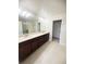 Spacious bathroom featuring double vanity, and a walk-in closet. Offers plenty of room at 11522 Cambium Crown Dr, Riverview, FL 33569