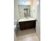 Stylish bathroom with granite vanity, drawers, mirror and modern fixtures, complemented by tiled floors at 11522 Cambium Crown Dr, Riverview, FL 33569