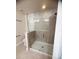 Well-lit bathroom with a modern glass shower, neutral tiling, and elegant fixtures at 11522 Cambium Crown Dr, Riverview, FL 33569