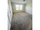 Bedroom with windows providing natural light, carpeted floor, and white walls at 11522 Cambium Crown Dr, Riverview, FL 33569