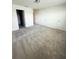 Large carpeted bedroom with multiple doorways, good lighting and white walls at 11522 Cambium Crown Dr, Riverview, FL 33569