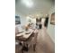Open dining room featuring a long table and cushioned chairs, leading to the kitchen at 11522 Cambium Crown Dr, Riverview, FL 33569