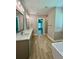 Modern bathroom with dual vanity, soaking tub, and walk-in shower at 13530 Oldenburg Dr, Hudson, FL 34667