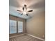 Cozy bedroom with fan, carpeted flooring, and natural light from windows at 13530 Oldenburg Dr, Hudson, FL 34667