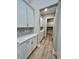 Butler's pantry with countertops, cabinets, and stylish backsplash at 13530 Oldenburg Dr, Hudson, FL 34667