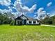 Inviting single-story home featuring stone accents and a well-manicured lawn at 13530 Oldenburg Dr, Hudson, FL 34667