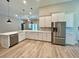Open kitchen featuring stainless steel appliances and white cabinets at 13530 Oldenburg Dr, Hudson, FL 34667