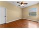 Bedroom boasts hardwood floors, neutral walls, light fixture, and one window at 614 Vintage Way, Brandon, FL 33511