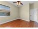Bedroom featuring wood floors, ceiling fan, and a view from the window at 614 Vintage Way, Brandon, FL 33511