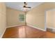 Bedroom boasts hardwood floors, neutral walls, light fixture, and large window at 614 Vintage Way, Brandon, FL 33511