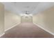 Spacious bonus room featuring neutral carpet, ceiling fan, and natural light at 614 Vintage Way, Brandon, FL 33511