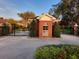 Gated community entrance with brick guardhouse and lush green landscaping at 614 Vintage Way, Brandon, FL 33511