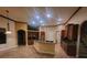 Well-lit kitchen with island, custom cabinetry, stainless appliances, and view to second floor landing at 614 Vintage Way, Brandon, FL 33511