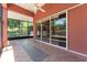 Covered lanai with tile flooring, ceiling fan, and sliding glass doors to the interior at 614 Vintage Way, Brandon, FL 33511