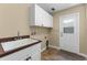Laundry room with white cabinets and a utility sink at 614 Vintage Way, Brandon, FL 33511